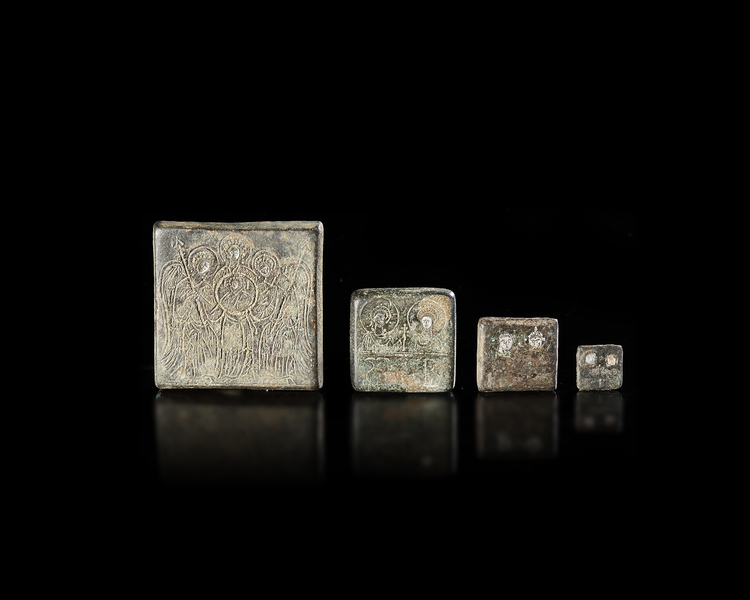 FOUR BYZANTINE COMMERCIAL WEIGHTS WITH SILVER INLAY, 5TH-7TH CENTURY AD