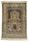 A FINE SILK AND METAL TURKISH HEREKE SILK RUG