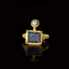 A GOLD RING WITH A BLUE GLASS INLAY, 1ST CENTURY AD OR LATER