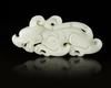 A CHINESE WHITE JADE BUDDHIST LION PENDANT, 20TH CENTURY