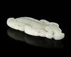A CHINESE WHITE JADE BUDDHIST LION PENDANT, 20TH CENTURY