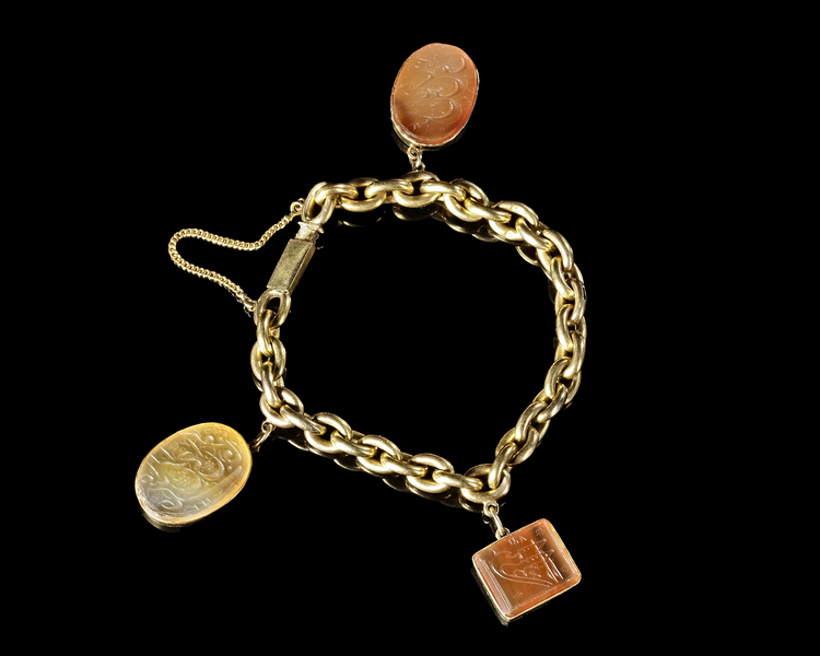 A GOLD BRACELET SET WITH THREE QAJAR AGATE SEALS, 19TH CENTURY