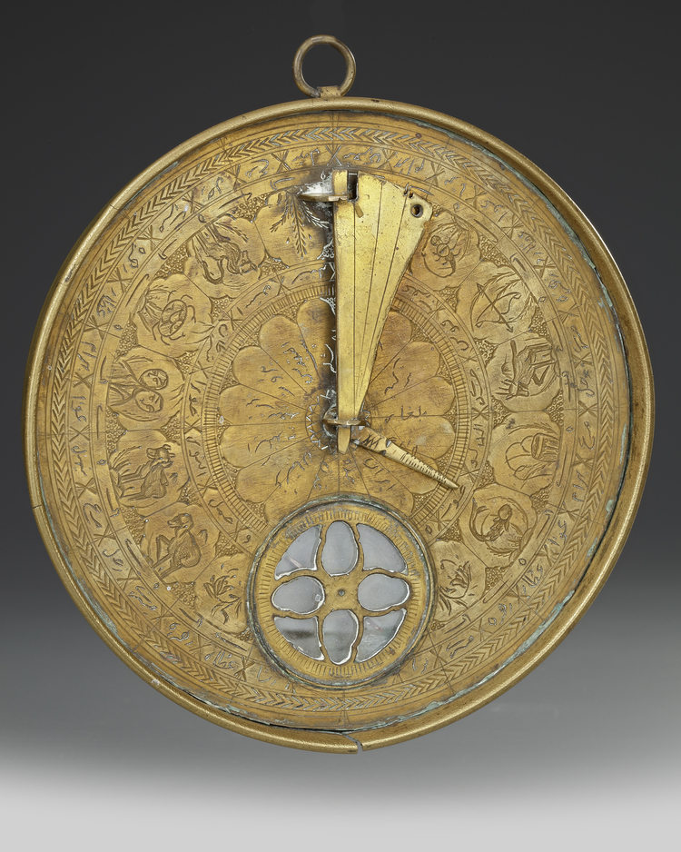 A QAJAR BRASS QIBLA INDICATOR, 19TH CENTURY