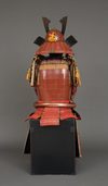 A RED LACQUER JAPANESE SUIT-OF-ARMOUR BY SATSUMA KUNIZUMI, 11TH GENERATION MITSUNOBU, MID 20TH CENTURY