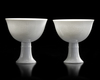 TWO CHINESE WHITE-GLAZED DRAGON AND PHOENIX STEM CUPS,  20TH CENTURY