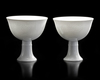 TWO CHINESE WHITE-GLAZED DRAGON AND PHOENIX STEM CUPS,  20TH CENTURY