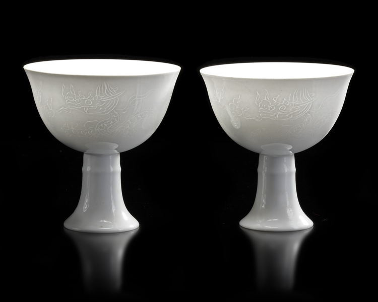 TWO CHINESE WHITE-GLAZED DRAGON AND PHOENIX STEM CUPS,  20TH CENTURY