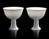 TWO CHINESE WHITE-GLAZED DRAGON AND PHOENIX STEM CUPS,  20TH CENTURY