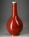 A CHINESE COPPER-RED-GLAZED BOTTLE VASE,QING DYNASTY (1644-1911)