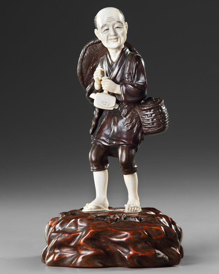 A JAPANESE BRONZE AND IVORY OKIMONO OF A PIPE SMOKER, MEIJI PERIOD (1868-1912)