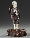 A JAPANESE BRONZE AND IVORY OKIMONO OF A PIPE SMOKER, MEIJI PERIOD (1868-1912)