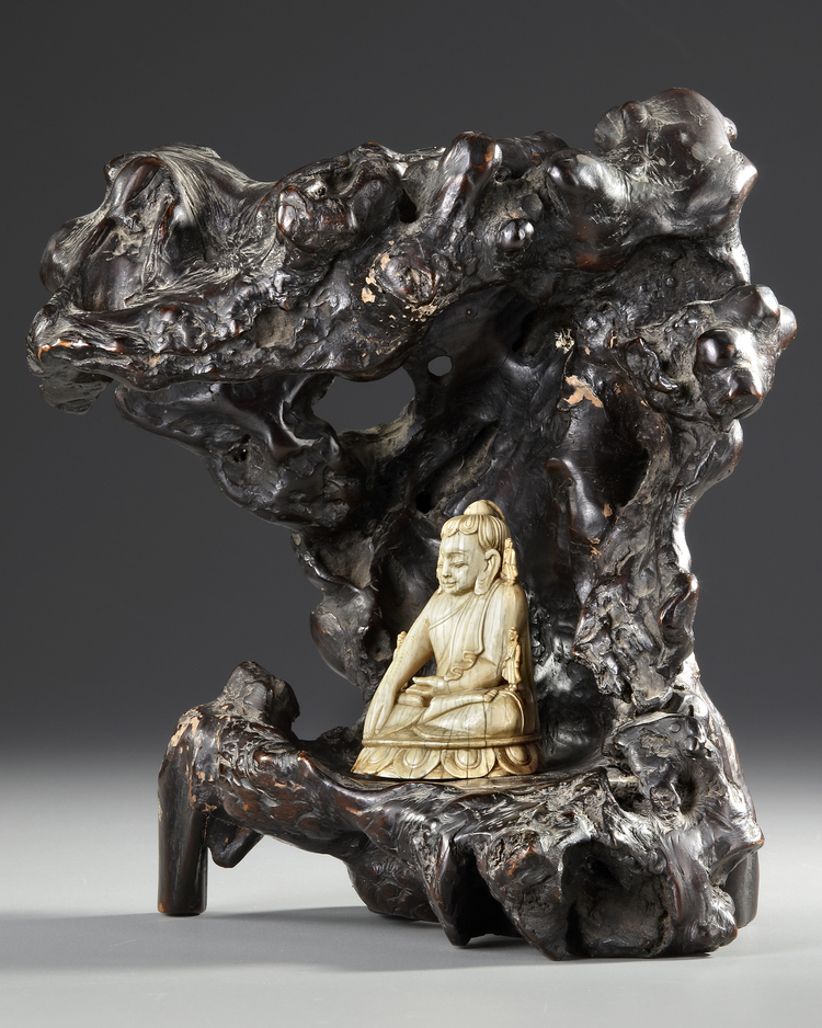 A CHINESE CARVED BONE FIGURE OF A BUDDHA WITH A CARVED WOODEN STAND