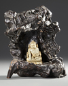 A CHINESE CARVED BONE FIGURE OF A BUDDHA WITH A CARVED WOODEN STAND