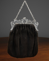 AN ART NOUVEAU SILVER PURSE BRACKET WITH BLACK VELVET TEXTILE PURSE, CIRCA 1920