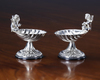 A PAIR OF SILVER SALTS SHAPED AS ANGELS MAKING MUSIC SEATED ON A SHELL (2)