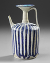 A KASHAN BLUE AND WHITE POTTERY EWER, PERSIA, 11TH-12TH CENTURY