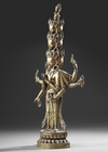 A SINO-TIBETAN GILT BRONZE AVALOKITESHVARA WITH MULTIPLE HEADS AND ARMS