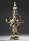 A SINO-TIBETAN GILT BRONZE AVALOKITESHVARA WITH MULTIPLE HEADS AND ARMS