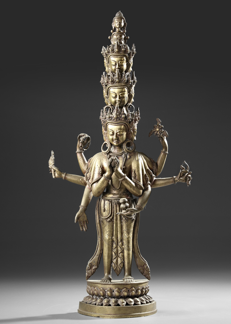 A SINO-TIBETAN GILT BRONZE AVALOKITESHVARA WITH MULTIPLE HEADS AND ARMS