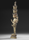 A SINO-TIBETAN GILT BRONZE AVALOKITESHVARA WITH MULTIPLE HEADS AND ARMS