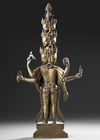 A SINO-TIBETAN GILT BRONZE AVALOKITESHVARA WITH MULTIPLE HEADS AND ARMS