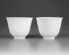 A  PAIR OF SMALL CHINESE WHITE-GLAZED DRAGONS CUPS, 20TH CENTURY