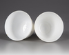 A  PAIR OF SMALL CHINESE WHITE-GLAZED DRAGONS CUPS, 20TH CENTURY