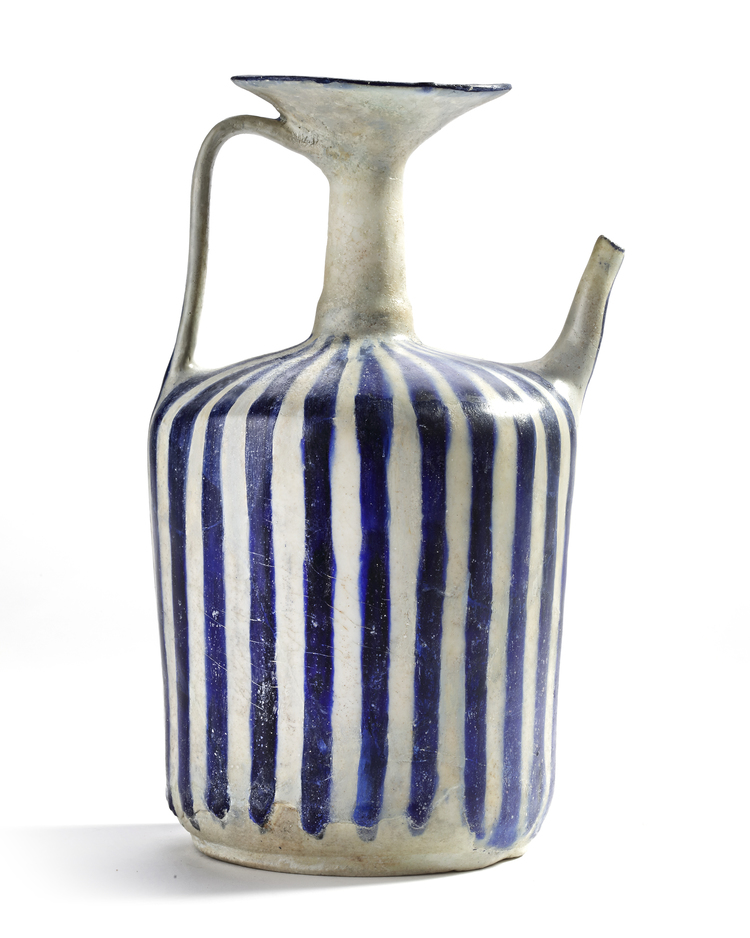 A KASHAN BLUE AND WHITE POTTERY EWER, PERSIA, 11TH-12TH CENTURY