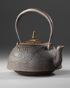 A JAPANESE CAST IRON TETSUBIN – CRANE AND WAVES DESIGN WITH BRONZE LID,EDO PERIOD (1615–1868)