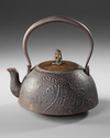 A JAPANESE CAST IRON TETSUBIN – CRANE AND WAVES DESIGN WITH BRONZE LID,EDO PERIOD (1615–1868)