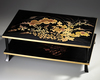 A LOW LACQUERED TWO-LEVEL JAPANESE TABLE WITH FLORAL DESIGNS, SHOWA PERIOD