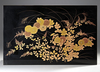 A LOW LACQUERED TWO-LEVEL JAPANESE TABLE WITH FLORAL DESIGNS, SHOWA PERIOD