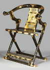 A BLACK LACQUERED JAPANESE FOLDABLE TEMPLE CHAIR WITH FLORAL MOTIFS,MEIJI PERIOD,1868-1912