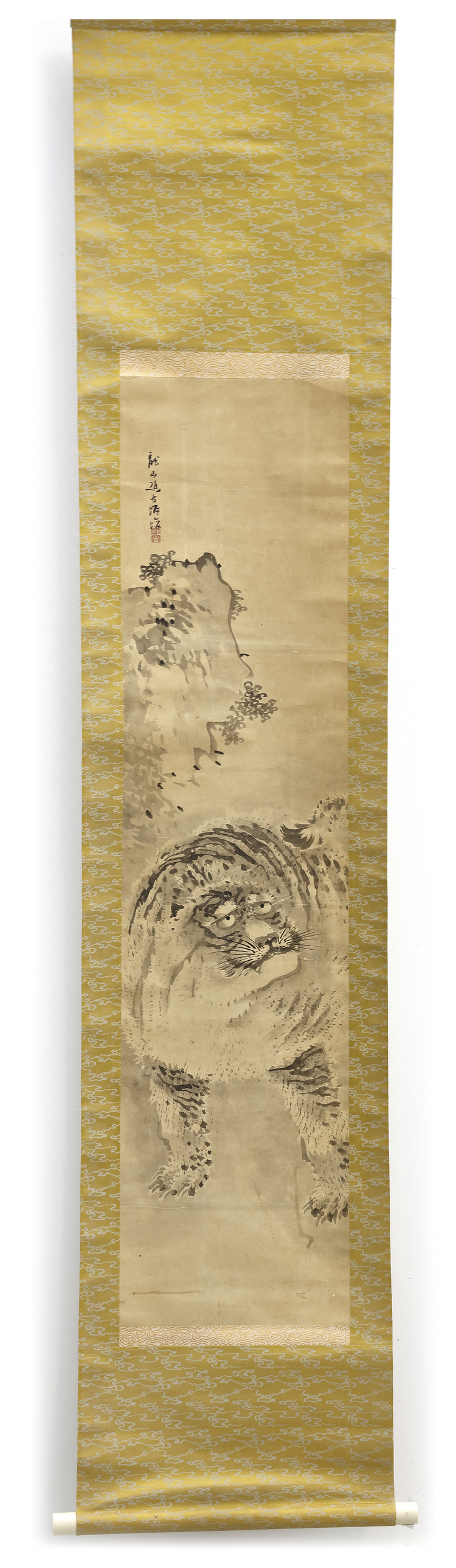 A JAPANESE SCROLL PAINTING OF A TIGER FEROCIOUSLY APPROACHING — SIGNED AND MOUNTED WITH GOLD BROCADE
