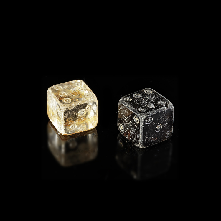 TWO CUBIC DICE: BLACK STONE, ROCK CRYSTAL, EAST PERSIA,  9TH–12TH CENTURY