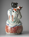 A JAPANESE FIGURE OF A BOY ON DRUM,1670-1690