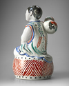 A JAPANESE FIGURE OF A BOY ON DRUM,1670-1690