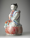 A JAPANESE FIGURE OF A BOY ON DRUM,1670-1690