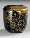 A NATSUME TEACADDY, FINELY LACQUERED WITH A LARGE RISING SUN SHINING THROUGH BRANCHES AND LEAVES, 20TH CENTURY