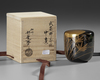 A NATSUME TEACADDY, FINELY LACQUERED WITH A LARGE RISING SUN SHINING THROUGH BRANCHES AND LEAVES, 20TH CENTURY