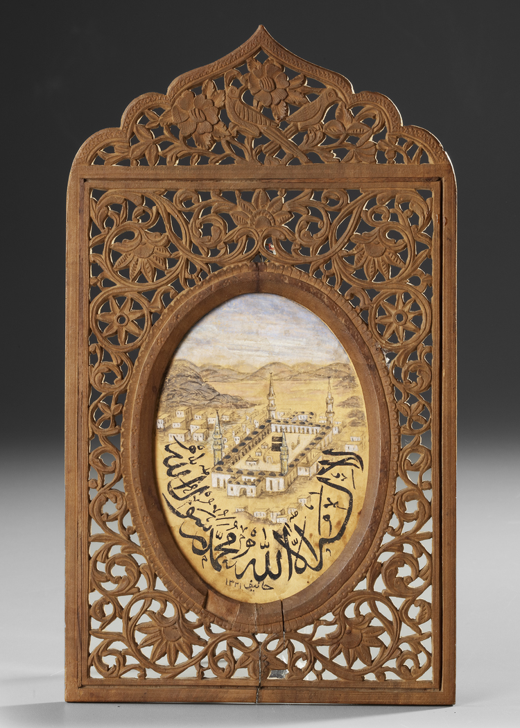 A SMALL PAINTING OF MECCA IN AN ORNATE WOODEN FRAME, DATED 1331 AH/1912 AD