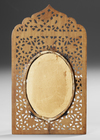 A SMALL PAINTING OF MECCA IN AN ORNATE WOODEN FRAME, DATED 1331 AH/1912 AD
