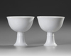 A PAIR OF CHINESE WHITE-GLAZED DRAGONS STEM CUPS, 20TH CENTURY