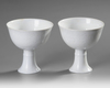 A PAIR OF CHINESE WHITE-GLAZED DRAGONS STEM CUPS, 20TH CENTURY