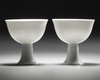 A PAIR OF CHINESE WHITE-GLAZED DRAGONS STEM CUPS, 20TH CENTURY