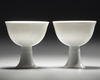 A PAIR OF CHINESE WHITE-GLAZED DRAGONS STEM CUPS, 20TH CENTURY