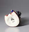 A JAPANESE KUTANI PORCELAIN FIGURE OF A GEISHA, SHOWA PERIOD, 1930's