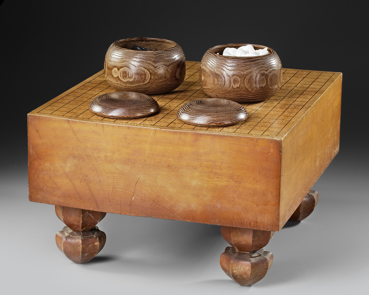 TRADITIONAL JAPANESE GO SET  DARK PATINATED WOODEN GO-BOARD WITH TWO ZELKOVA-WOOD  BOXES, 20TH CENTURY
