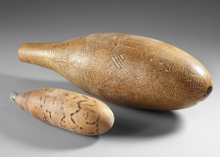 One Sentani gourd lime container and a large Dani water container (with crack) from the Baliem valley.