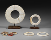 Small collection of fossil Tridacna shell valuables. Two rings on custom made stands from the Solomon Islands